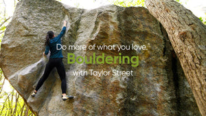 A lady bouldering with an Owala bottle.