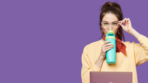 Owala bottle being held by a girl with a laptop