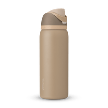 Full profile shot of the 32oz Down to Earth FreeSip water bottle in tan, highlighting its tan and silt colors.
